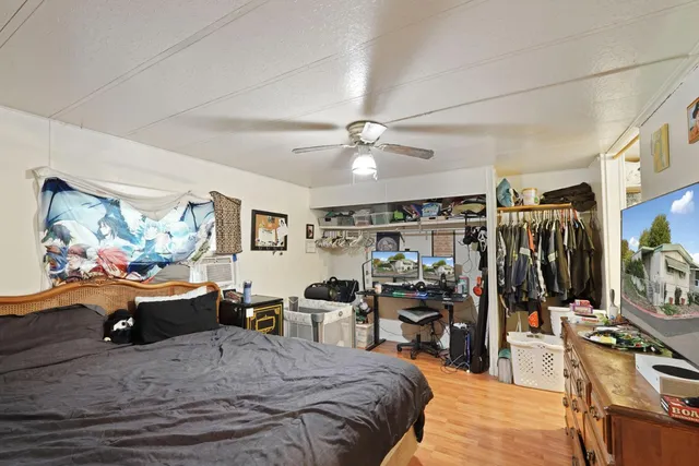 a bedroom with a bed and a chandelier