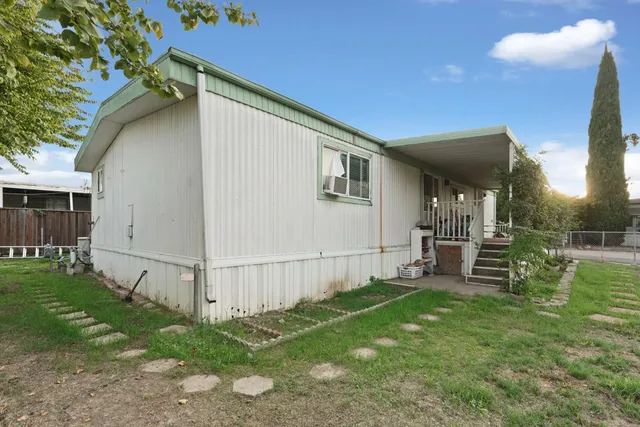 a backyard of a house with outdoor seating