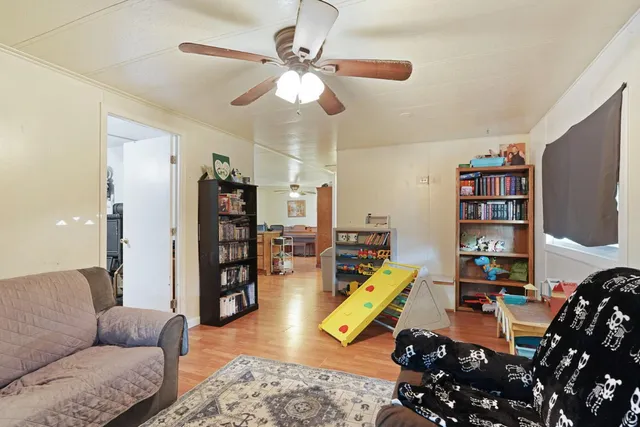a kitchen with stainless steel appliances kitchen island granite countertop a refrigerator and wooden cabinets