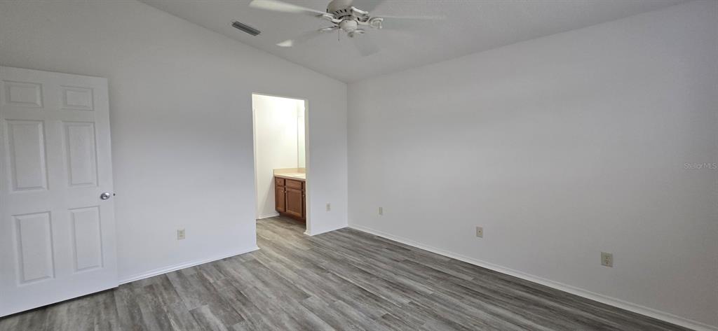 1009 Ridgeville Road The Villages, FL 32162 - Photo 13 of 16 a view of a room with wooden floor and white walls