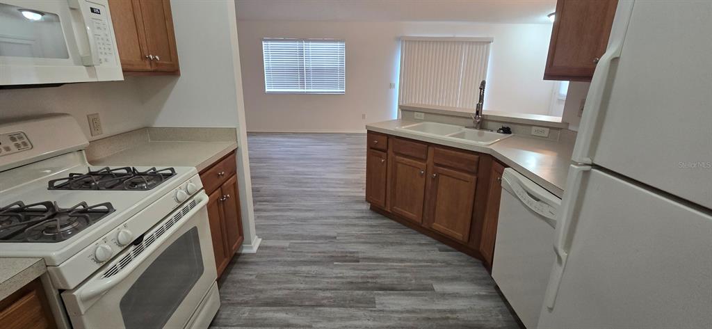 1009 Ridgeville Road The Villages, FL 32162 - Photo 4 of 16 a kitchen with a stove and a wooden floor