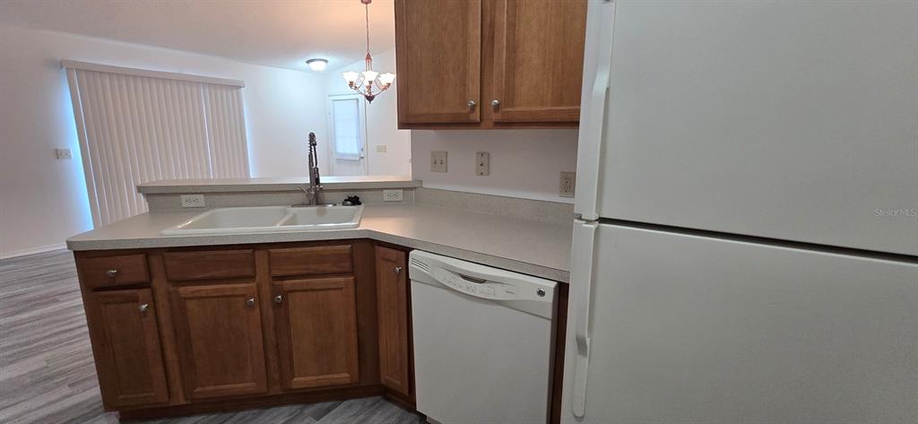 1009 Ridgeville Road The Villages, FL 32162 - Photo 6 of 16 a kitchen with a sink and a refrigerator