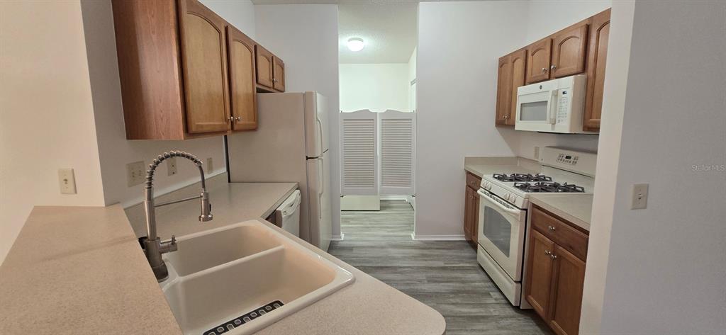 1009 Ridgeville Road The Villages, FL 32162 - Photo 8 of 16 a kitchen with stainless steel appliances granite countertop a stove and a sink
