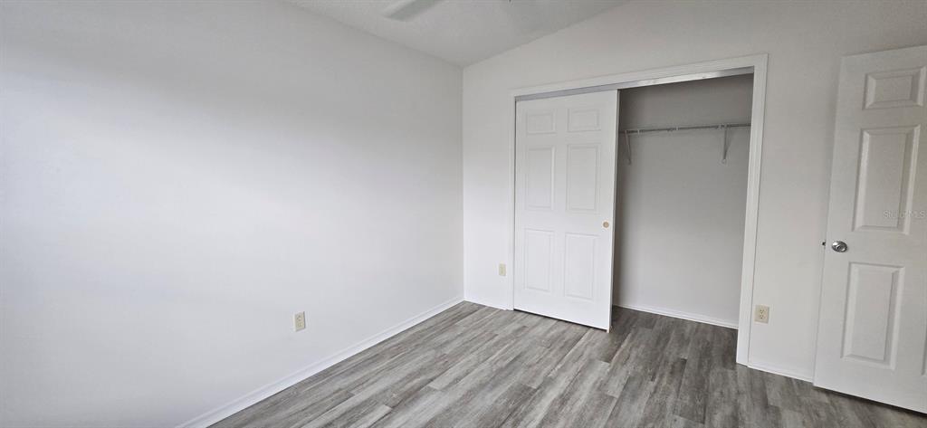 1009 Ridgeville Road The Villages, FL 32162 - Photo 10 of 16 a view of an empty room with wooden floor