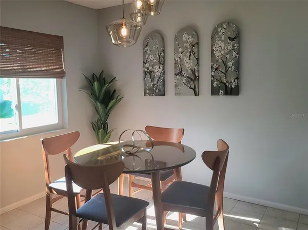 a view of a dining room with furniture and chandelier