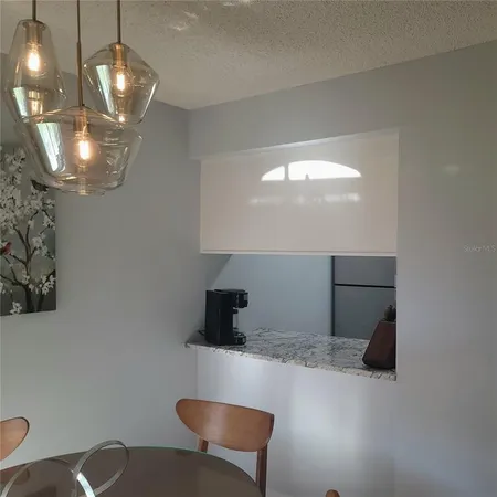 a kitchen with cabinets and a chandelier