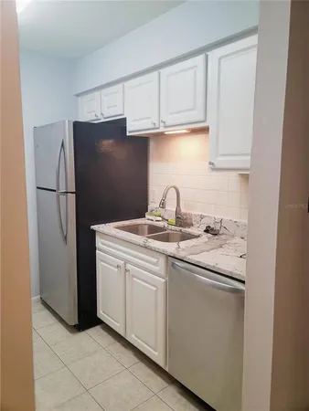 a kitchen with a sink and a refrigerator