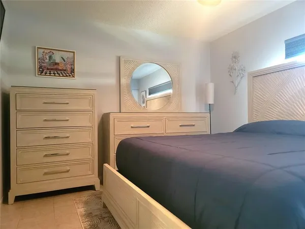 a bedroom with a bed and a dresser