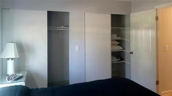 a view of walk in closet with empty racks