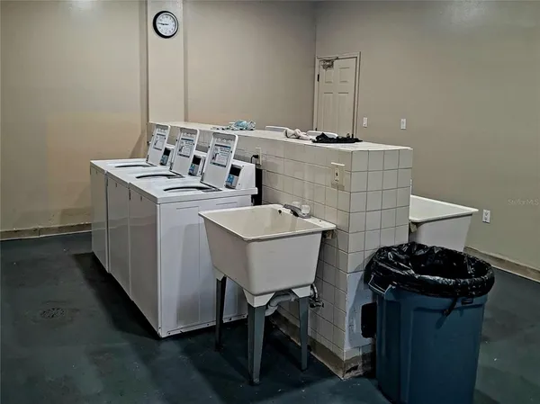 a utility room with sink dryer and washer