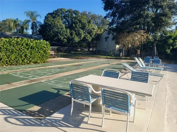 a view of a patio with table and chairs and potted plants