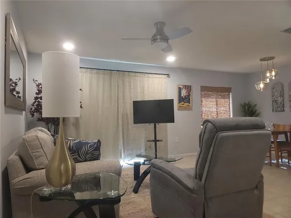a living room with furniture and a flat screen tv