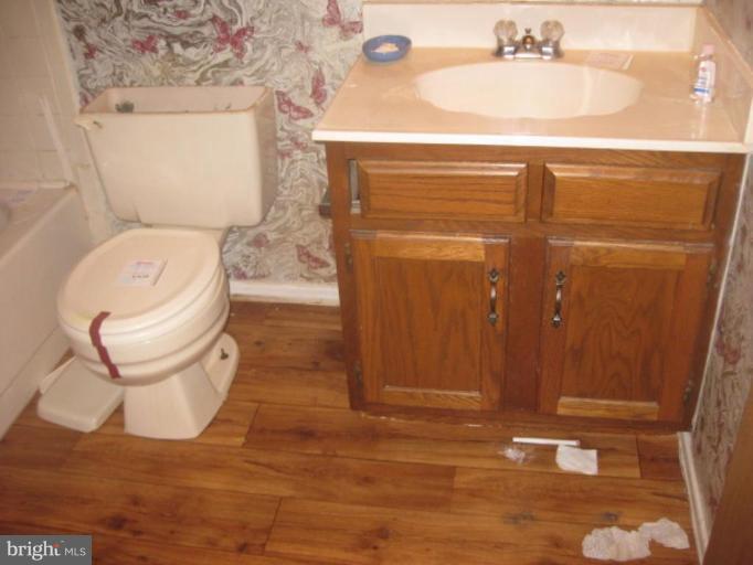 100 Sandhill Road Essex, MD 21221 - Photo 7 of 10 a bathroom with a toilet and a sink