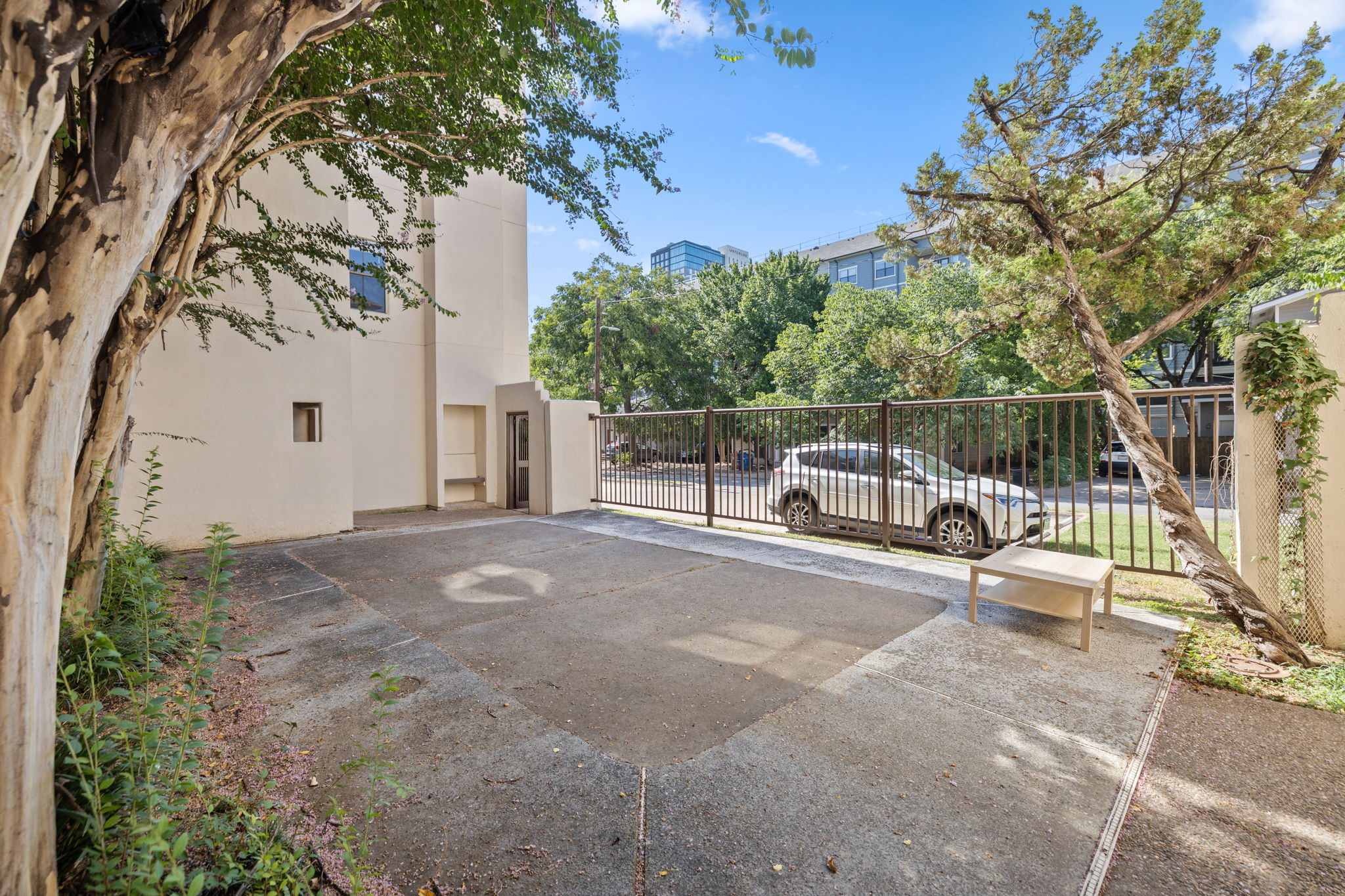 712 Graham Place, Unit 203 Austin, TX 78705 - Photo 3 of 30 a white house with tall trees in front of it