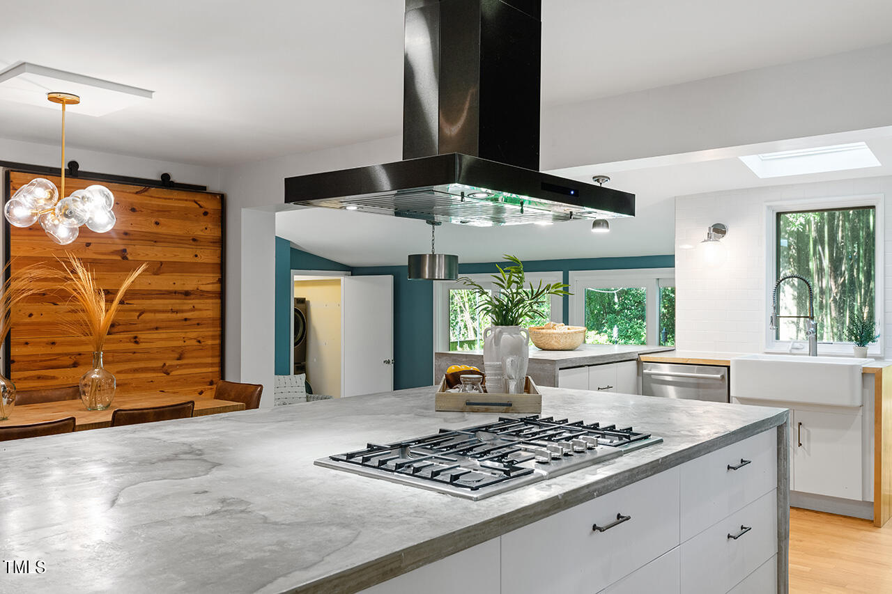 1607 Lorraine Road Raleigh, NC 27607 - Photo 11 of 37 a kitchen with stainless steel appliances granite countertop a stove and a refrigerator