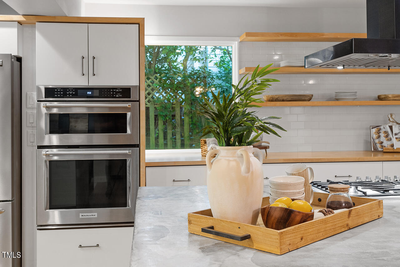1607 Lorraine Road Raleigh, NC 27607 - Photo 16 of 37 a living room with furniture and a fireplace