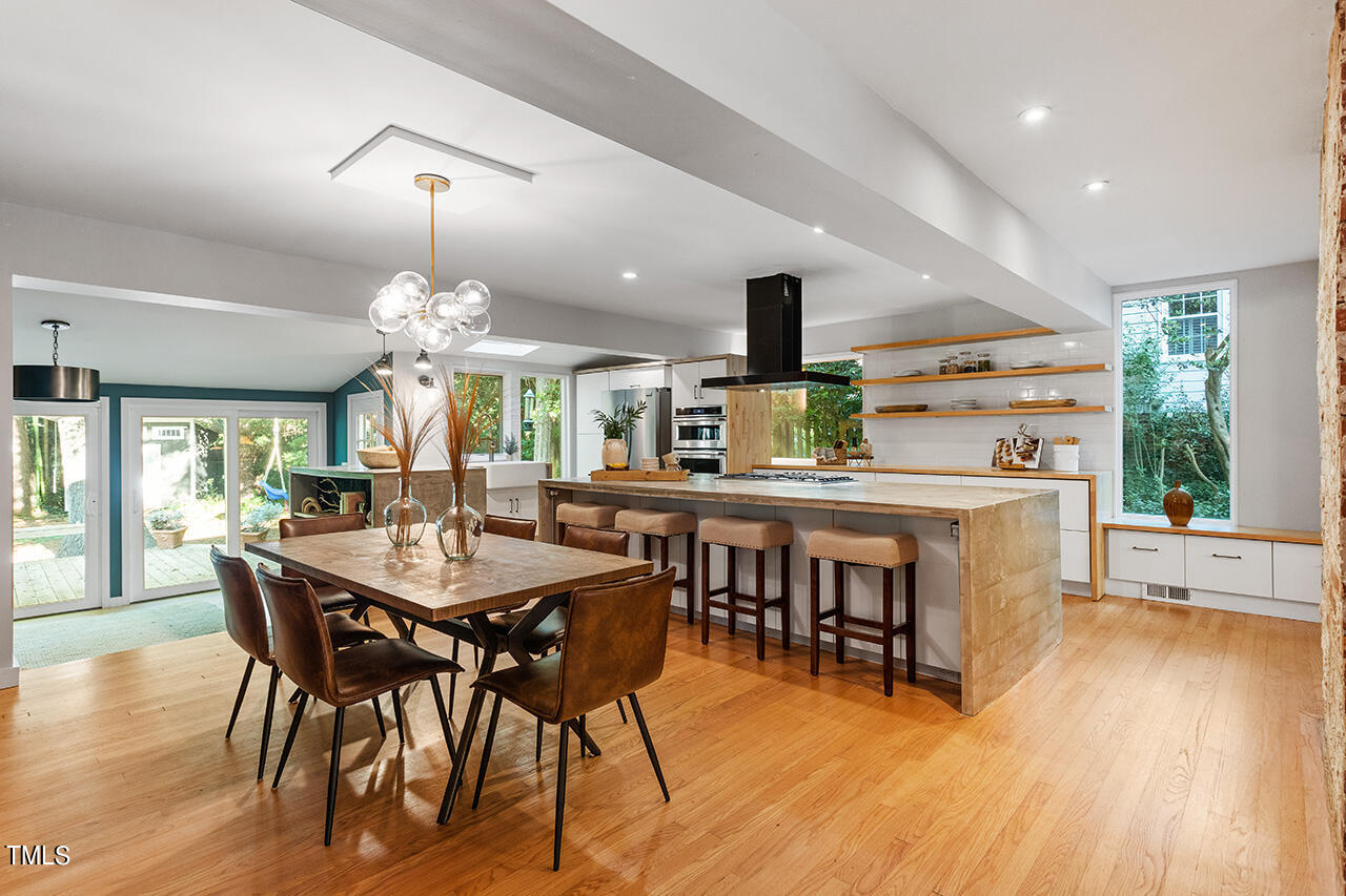 1607 Lorraine Road Raleigh, NC 27607 - Photo 19 of 37 a view of a dining room with furniture window and wooden floor