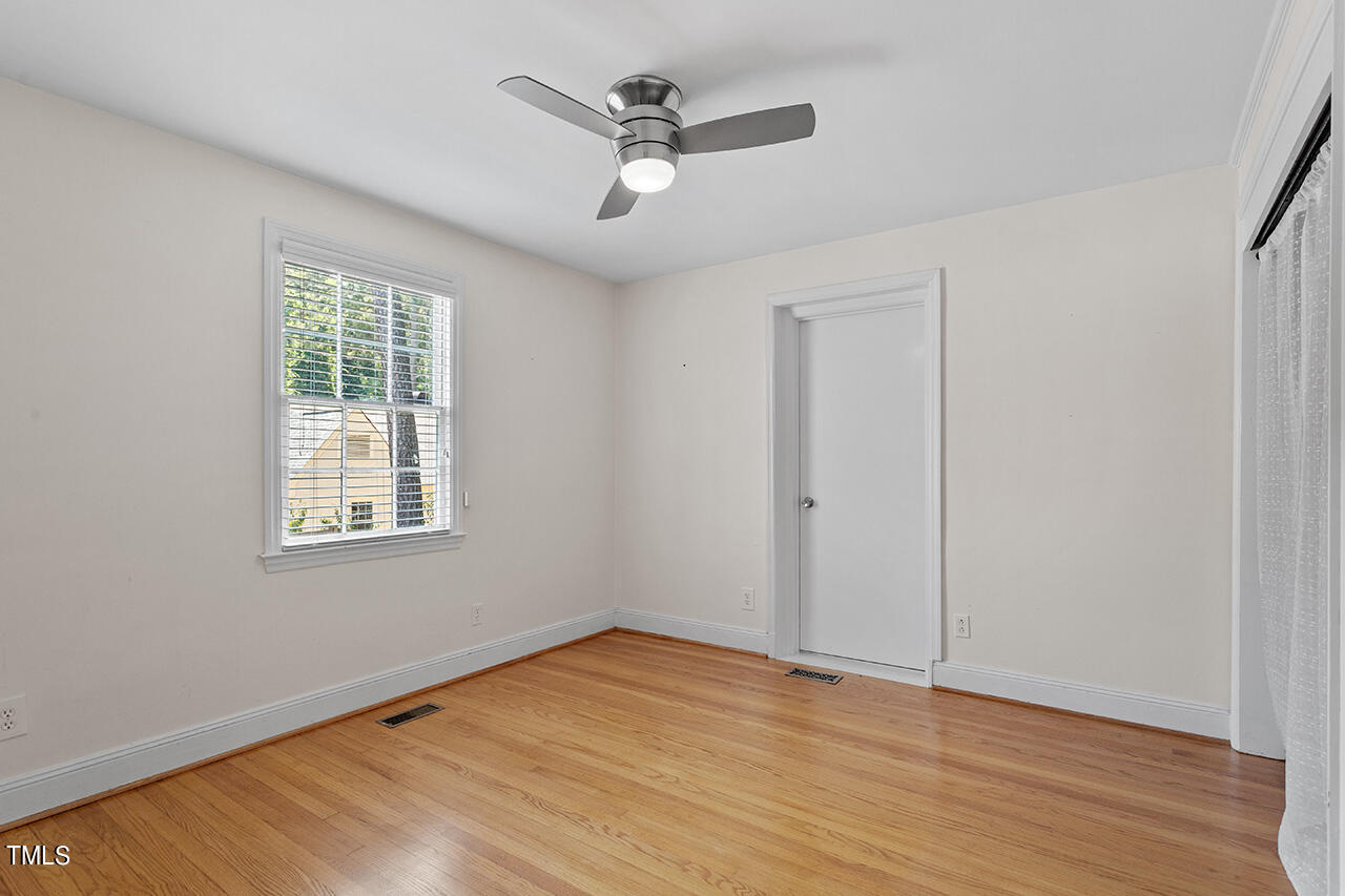 1607 Lorraine Road Raleigh, NC 27607 - Photo 24 of 37 a view of an empty room with wooden floor and a window