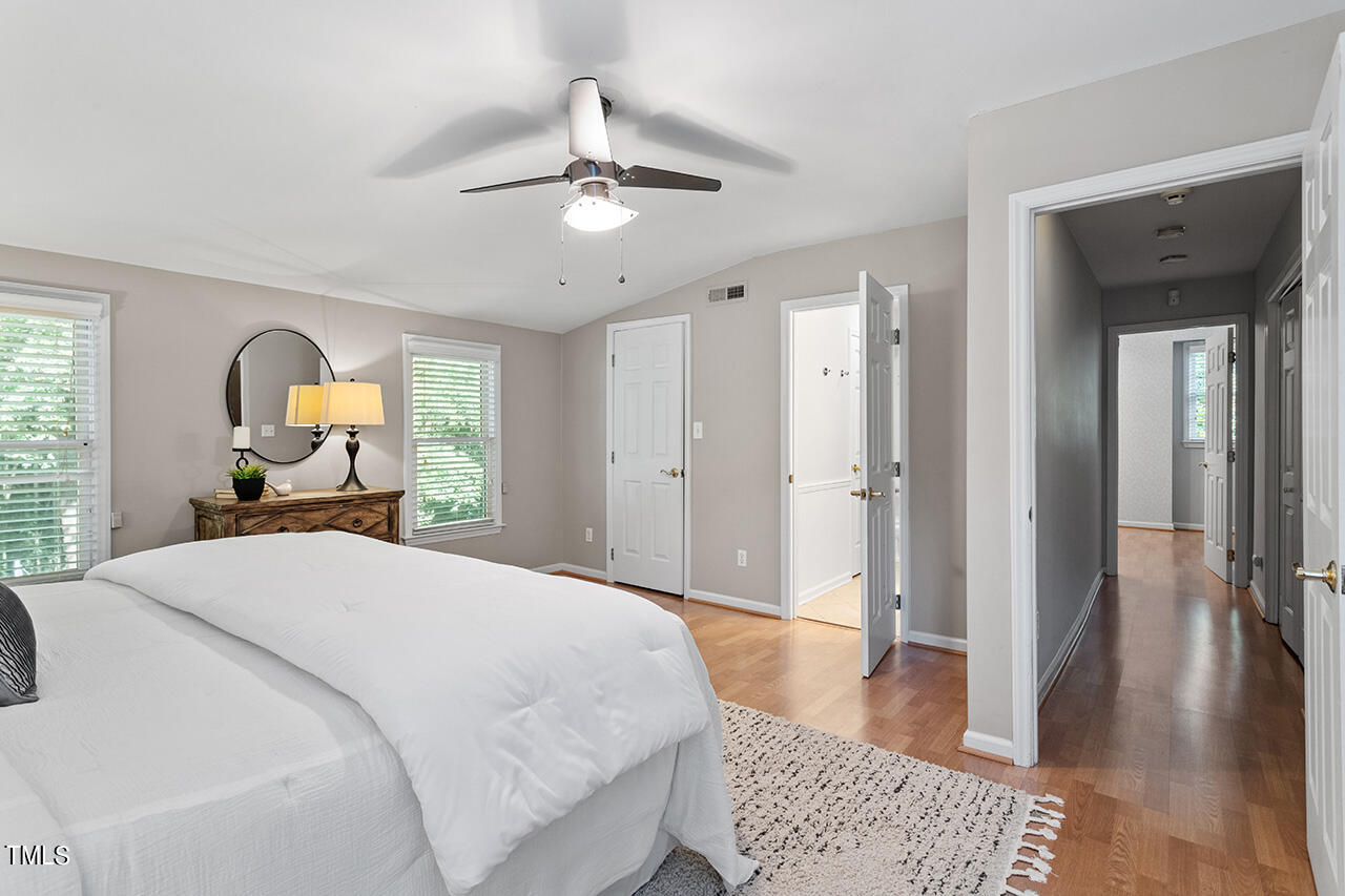 1607 Lorraine Road Raleigh, NC 27607 - Photo 27 of 37 a bedroom with a bed and a chandelier