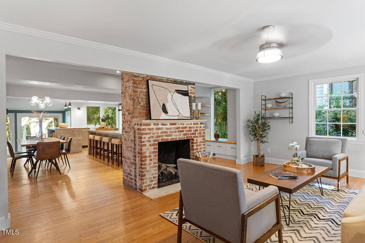1607 Lorraine Road Raleigh, NC 27607 - Photo 3 of 37 a living room with furniture a fireplace and a large window