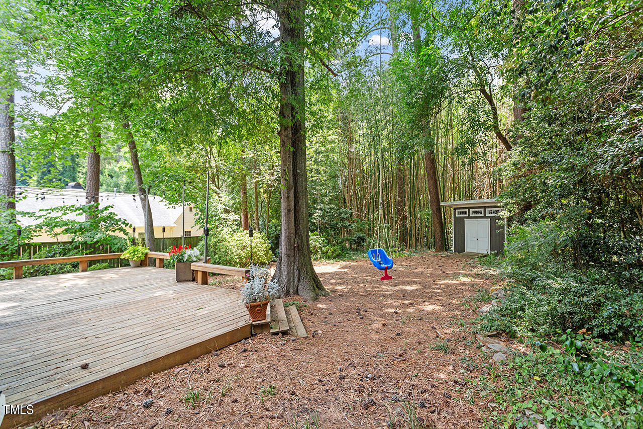 1607 Lorraine Road Raleigh, NC 27607 - Photo 34 of 37 a wooden bench sitting in front of a building