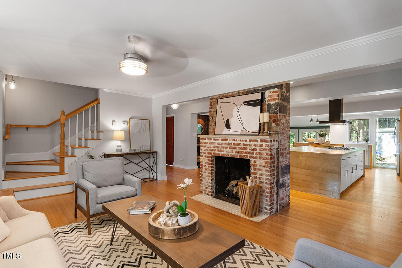 1607 Lorraine Road Raleigh, NC 27607 - Photo 4 of 37 a living room with furniture and a fireplace