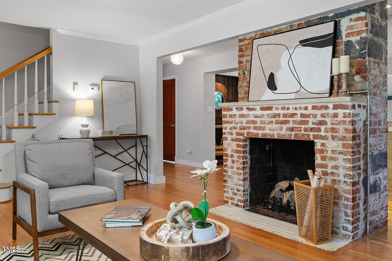 1607 Lorraine Road Raleigh, NC 27607 - Photo 6 of 37 a living room with furniture and a fireplace