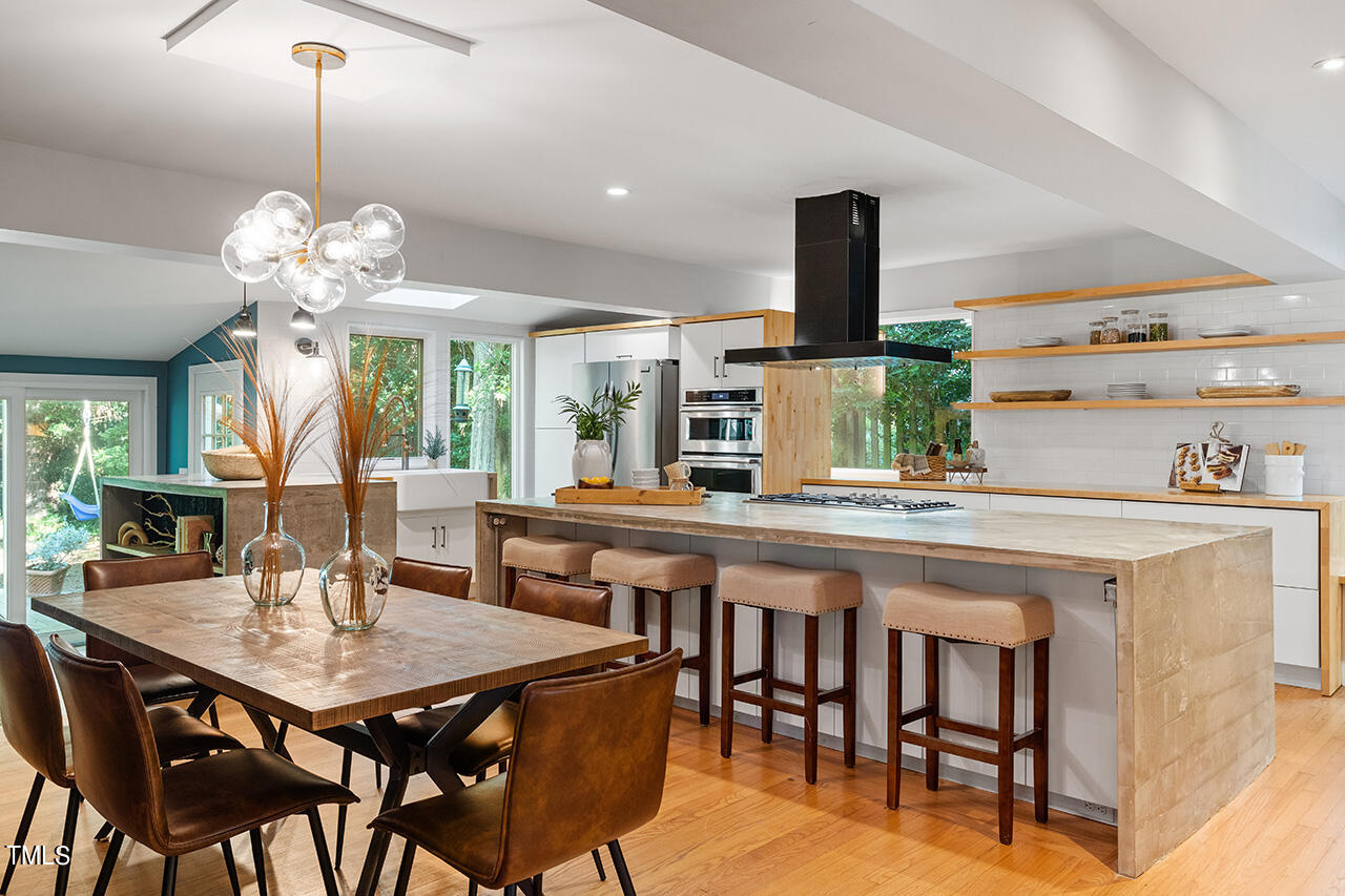 1607 Lorraine Road Raleigh, NC 27607 - Photo 8 of 37 a kitchen with a table and chairs in it