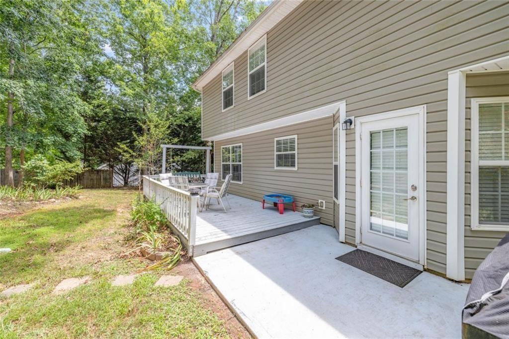 3286 High View Court Gainesville, GA 30506 - Photo 10 of 38 a view of a patio with table and chairs potted plants and large tree