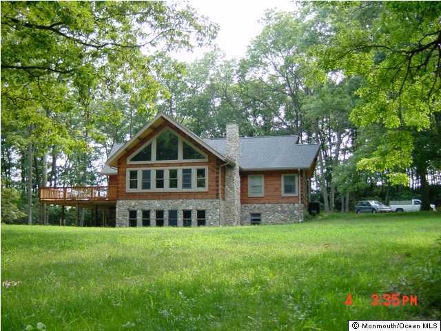 111 Tyrpak Road Howell, NJ 07731 - Photo 1 of 13 a front view of house with yard and green space