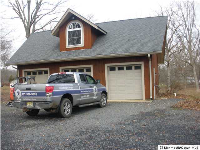 111 Tyrpak Road Howell, NJ 07731 - Photo 9 of 13 a car parked in front of a house