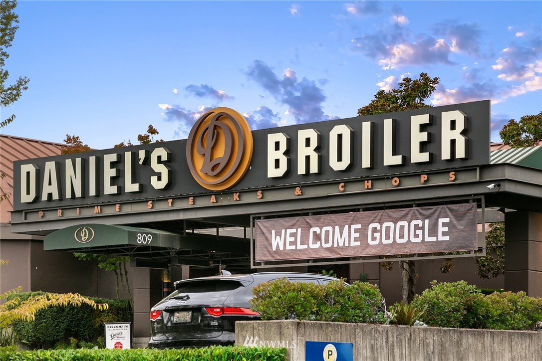 63 East Lynn Street Seattle, WA 98102 - Photo 17 of 20 a front view of multi story building with retail shop and car parked