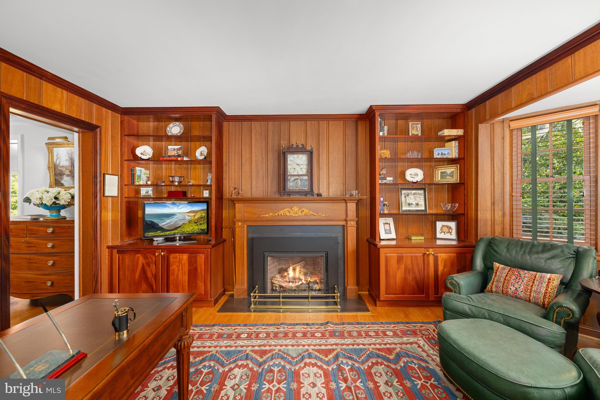 3730 Cardiff Road Chevy Chase, MD 20815 - Photo 20 of 49 a living room with furniture a fireplace and a floor to ceiling window