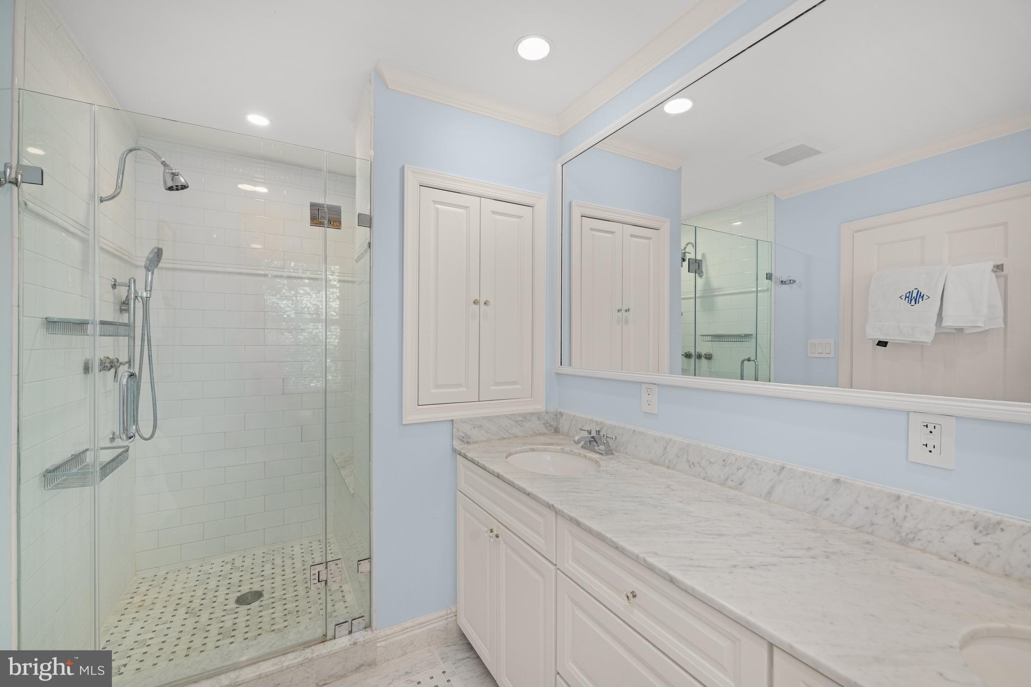 3730 Cardiff Road Chevy Chase, MD 20815 - Photo 25 of 49 a bathroom with a granite countertop sink mirror and shower