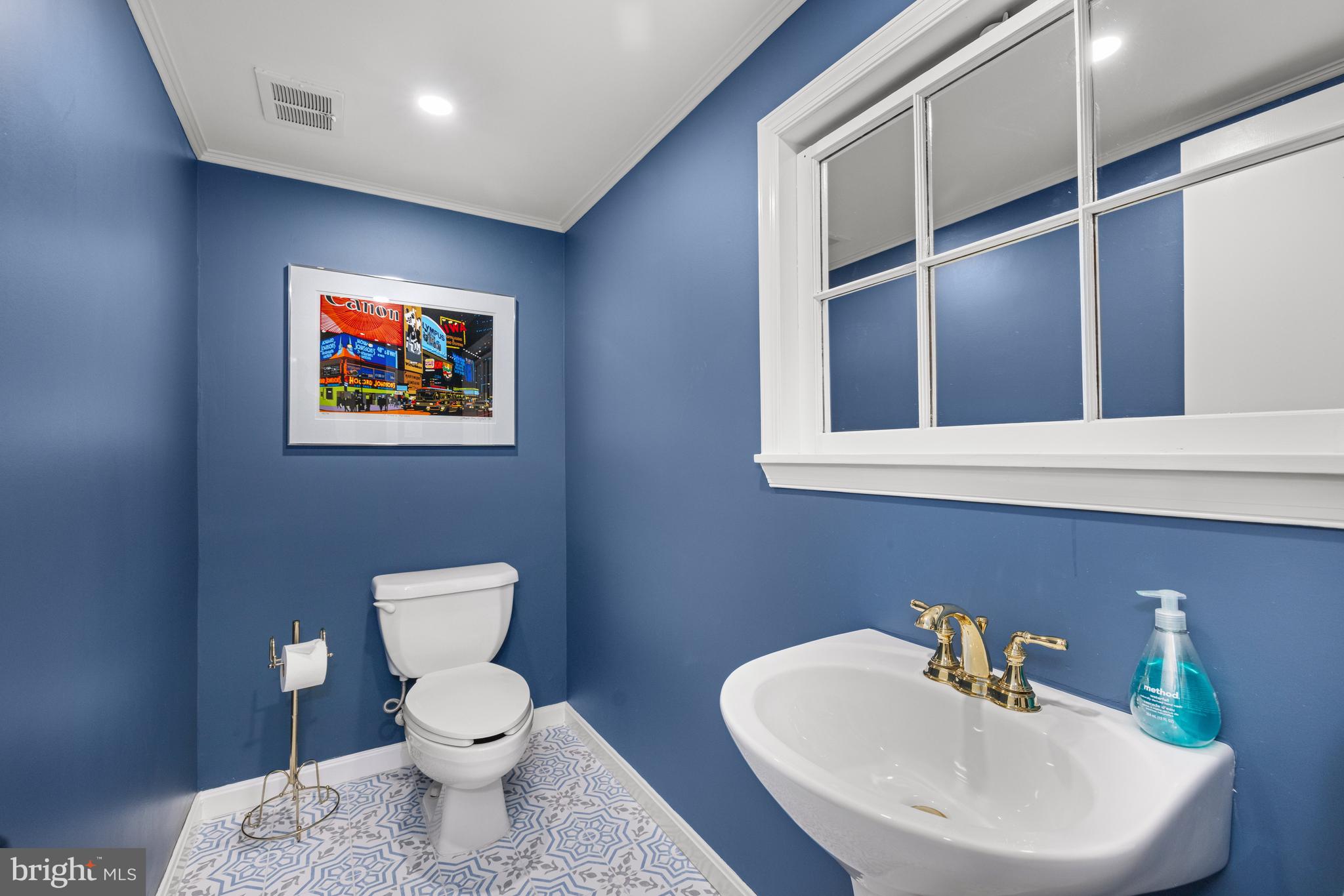 3730 Cardiff Road Chevy Chase, MD 20815 - Photo 39 of 49 a bathroom with a toilet a sink and mirror