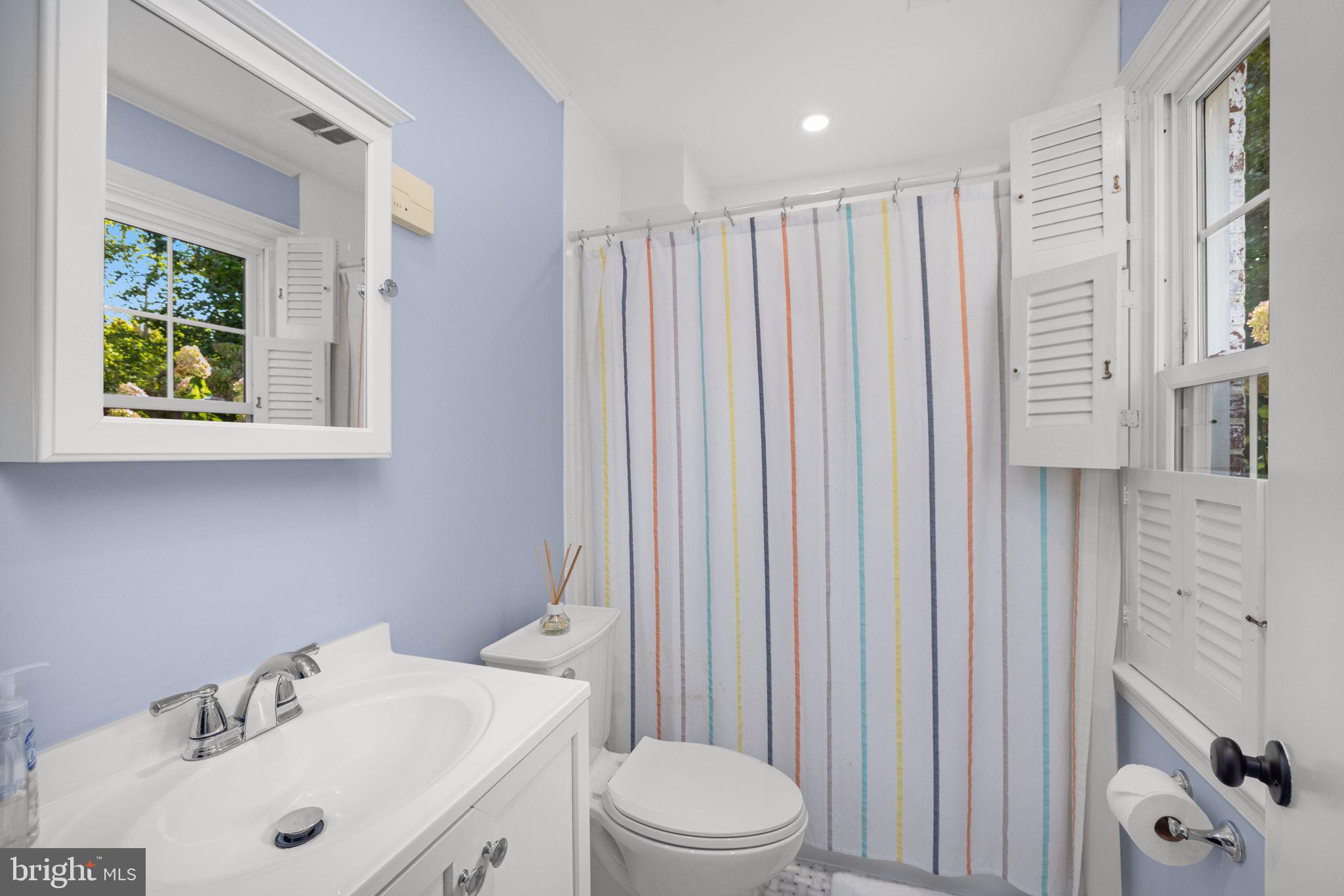 3730 Cardiff Road Chevy Chase, MD 20815 - Photo 43 of 49 a bathroom with a sink a toilet and shower curtain