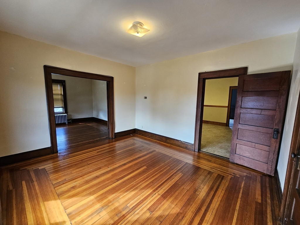 30 Bemis Street, Unit 3 Chicopee, MA 01013 - Photo 11 of 26 a bedroom with a bed and wooden floor