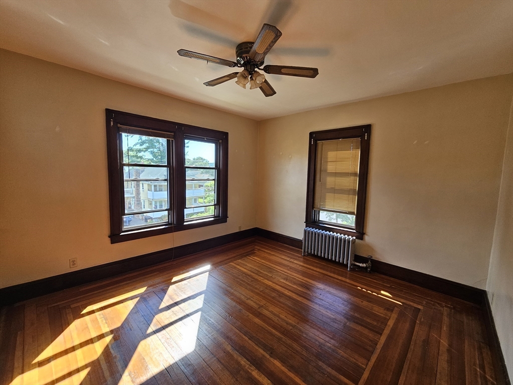 30 Bemis Street, Unit 3 Chicopee, MA 01013 - Photo 13 of 26 a view of an empty room with a window and wooden floor