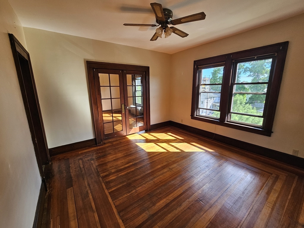 30 Bemis Street, Unit 3 Chicopee, MA 01013 - Photo 14 of 26 a view of an empty room with wooden floor and a window