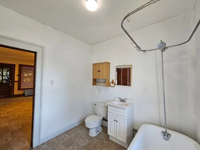 an empty room with closet and a window