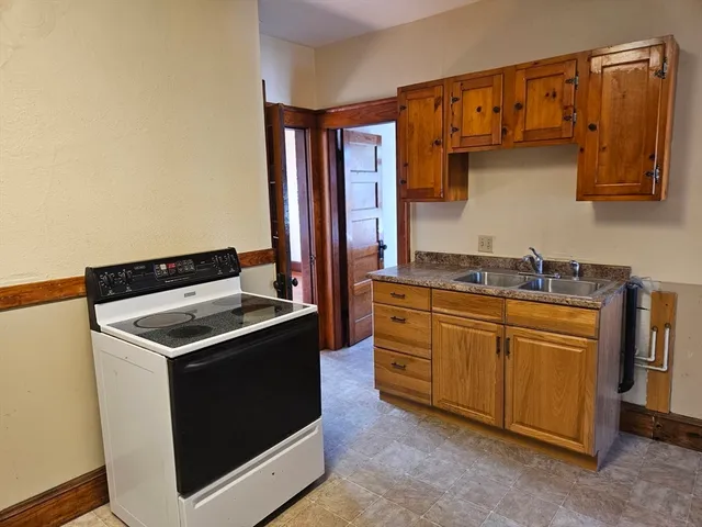 a kitchen that has a sink and a stove