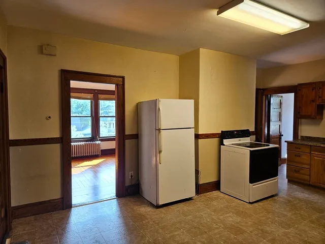 a kitchen with a refrigerator and a stove
