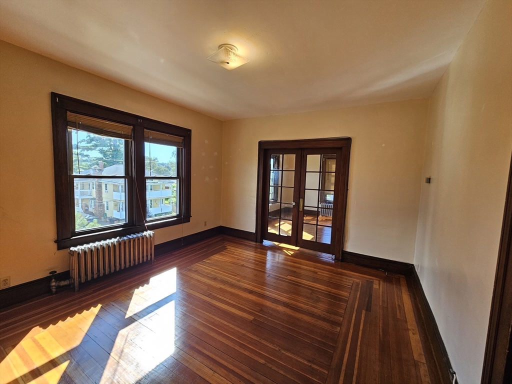 30 Bemis Street, Unit 3 Chicopee, MA 01013 - Photo 10 of 26 a view of an empty room with wooden floor and a window