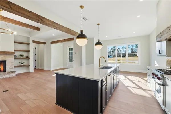 an empty room with ceiling fan and windows