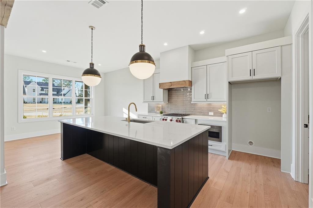 157 Palisade Drive Rydal, GA 30171 - Photo 17 of 67 a kitchen with kitchen island a sink white cabinets and stainless steel appliances