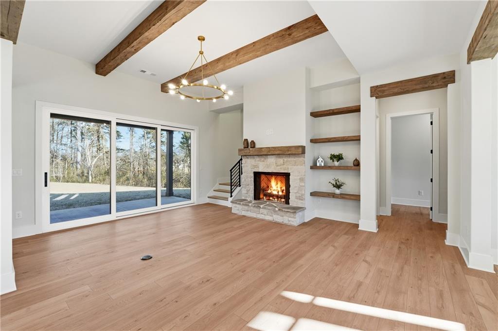 157 Palisade Drive Rydal, GA 30171 - Photo 21 of 67 a view of empty room with wooden floor and fireplace