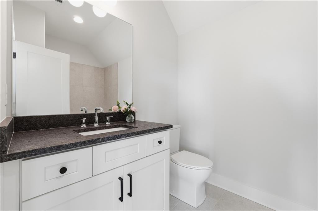 157 Palisade Drive Rydal, GA 30171 - Photo 49 of 67 a bathroom with a granite countertop sink a toilet and a mirror