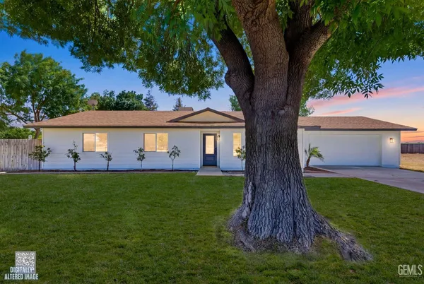 a view of house with backyard