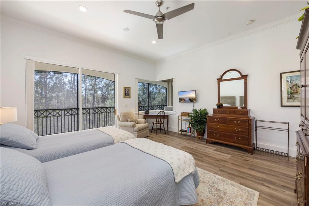 2870 Castillo Court, Unit 103 Naples, FL 34109 - Photo 12 of 34 a bedroom with a bed and a large window
