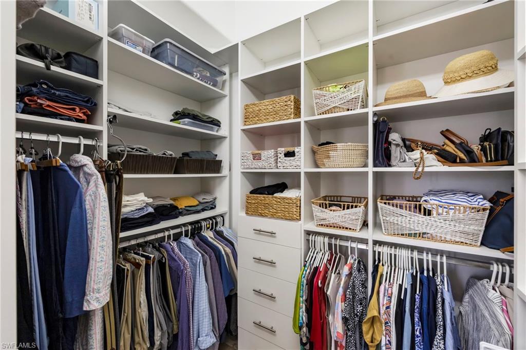 2870 Castillo Court, Unit 103 Naples, FL 34109 - Photo 15 of 34 a view of walk in closet with clothes and shoes